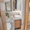 Bailey Adamo 75-4DL mid washroom featuring vanity cupboard with mirrored door and toothbrush holder